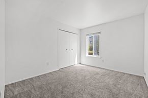 Southfield apartment for rent - A room with a carpeted floor and a window showing a building outside.