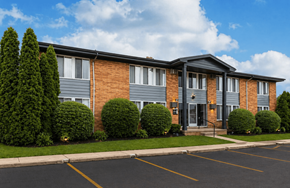 Roseville townhouse for rent - A building with a parking lot in front of it.