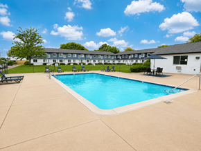 Canton townhouse for rent - A large swimming pool in front of a building with a white exterior.