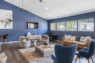Grand Rapids townhouse for rent - A living room with a white sofa and a blue chair.
