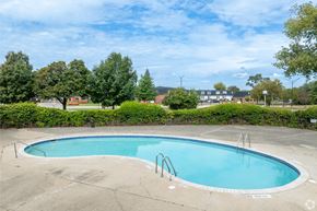 Southfield apartment for rent - A small pool surrounded by a concrete deck and a hedge.
