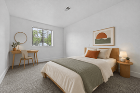 Grand Rapids apartment for rent - A bedroom with a large bed and a desk with a chair.