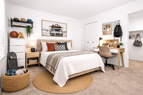 Novi apartment for rent - A bedroom with a bed, desk, chair, and a rug.