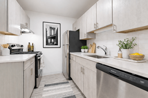 Novi apartment for rent - A kitchen with white cabinets and a black fridge.