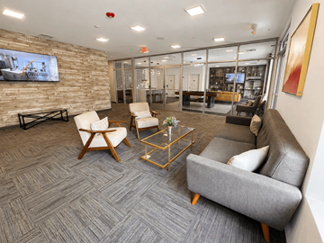 White Lake apartment for rent - A modern living room with a grey carpet and a stone wall.
