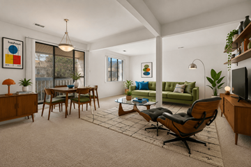 Southfield apartment for rent - A living room with a green couch and a wooden chair.