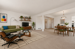 Southfield apartment for rent - A living room with a green couch, a coffee table, and a TV.