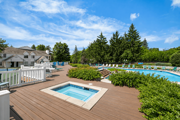 Farmington Hills apartment for rent - A pool surrounded by a deck and trees.