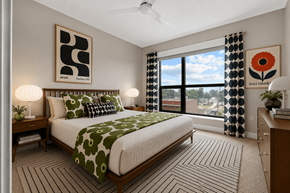 Royal Oak apartment for rent - A bedroom with a large bed and a ceiling fan.