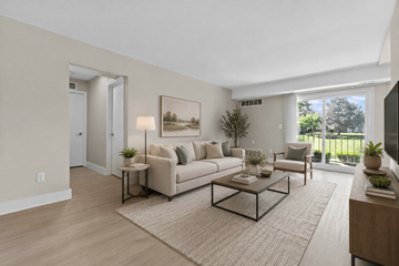 Troy apartment for rent - A living room with a couch, coffee table, and a painting on the wall.