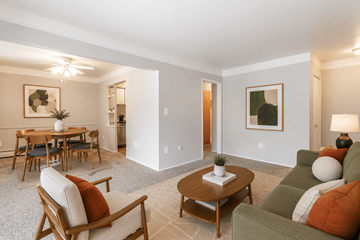 Saginaw apartment for rent - A living room with a wooden table and chairs.