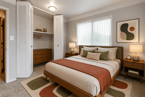 Saginaw apartment for rent - A bedroom with a large bed and a wooden nightstand.