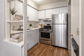Saginaw apartment for rent - A modern kitchen with a stainless steel refrigerator and white cabinets.