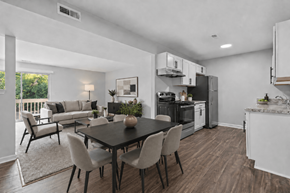 Flint apartment for rent - A modern kitchen with a dining table and chairs.