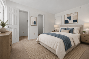 Flint apartment for rent - A bedroom with a large bed and a wooden dresser.