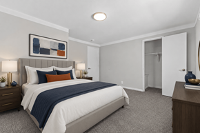 Oak Park townhouse for rent - A bedroom with a large bed and a painting on the wall.