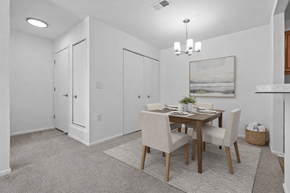 Canton apartment for rent - A dining room with a table set for two and a painting on the wall.