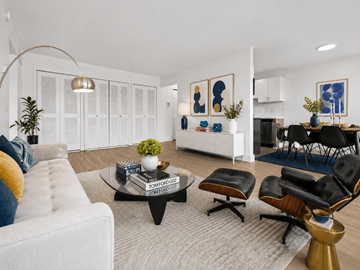 Auburn Hills apartment for rent - A living room with a white couch, a coffee table, and a dining table with chairs.