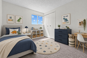 Sterling Heights townhouse for rent - A bedroom with a bed, desk, and a rug with a dinosaur print.