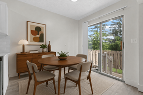 Sterling Heights townhouse for rent - A dining room with a wooden table and chairs.