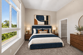 White Lake apartment for rent - A bedroom with a large bed and a painting on the wall.