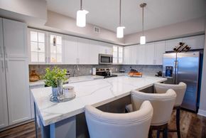 Royal Oak apartment for rent - a large kitchen with white cabinets and white counter tops