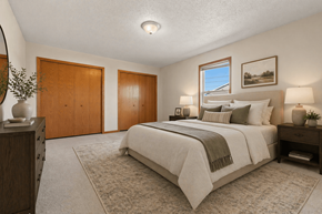Freeland triplex for rent - A bedroom with a large bed and a window.