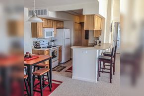 Petoskey apartment for rent - a view of a kitchen and a dining room with a table and chairs