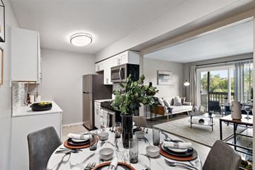 Grand Blanc Twp apartment for rent - a kitchen and living room with a table and chairs