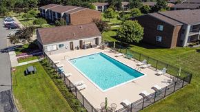 Troy apartment for rent - an aerial view of a swimming pool in front of a house at Sunnymede Apartments - Troy, MI, Michigan