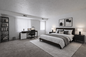 Southfield apartment for rent - A bedroom with a bed, desk, and chair.