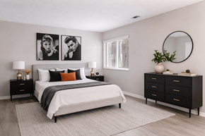 Grand Rapids townhouse for rent - A bedroom with a large bed, a nightstand, and a dresser.