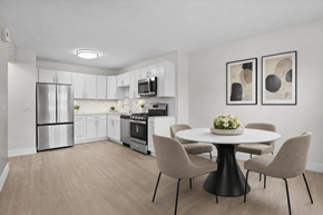 Canton townhouse for rent - A modern kitchen with a dining table set for four.
