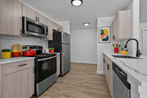Southfield apartment for rent - A kitchen with a black refrigerator and stove top oven.