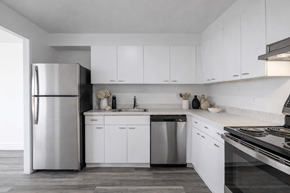 Southfield apartment for rent - A modern kitchen with white cabinets and stainless steel appliances.
