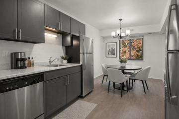 Detroit apartment for rent - A modern kitchen with a dining table and chairs.