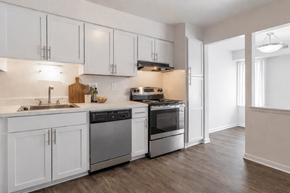 Southfield apartment for rent - A modern kitchen with white cabinets and stainless steel appliances.