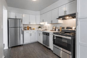 Southfield apartment for rent - A modern kitchen with white cabinets and stainless steel appliances.