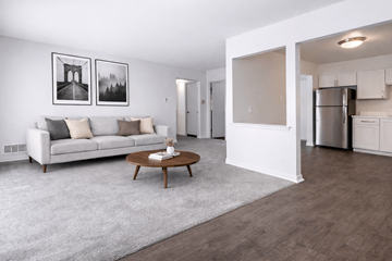 Southfield apartment for rent - A modern living room with a white couch and a coffee table.