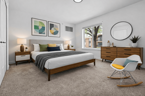 Southfield apartment for rent - A bedroom with a bed, nightstands, and a chair.