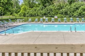 Flint apartment for rent - a swimming pool with chairs around it and a wooden fence