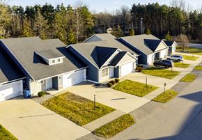 Midland townhouse for rent - a group of houses with blue roofs and trees in the background