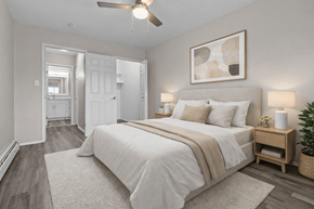 Plymouth apartment for rent - A bedroom with a large bed and a ceiling fan.