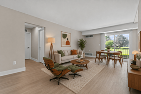Troy apartment for rent - A living room with a white couch, a wooden coffee table, and a rug.