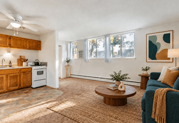 Ann Arbor apartment for rent - A living room with a blue couch and a wooden coffee table.