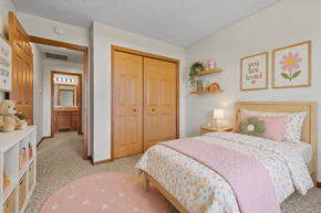 Saginaw townhouse for rent - A bedroom with a bed, a dresser, and a shelf with a sign that says "you are loved".