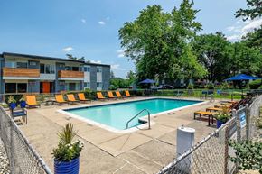 Ann Arbor townhouse for rent - A pool area with a fence and a building in the background.