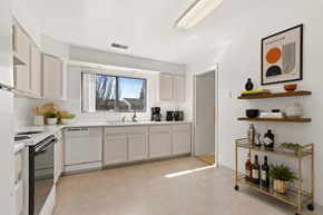 Southfield apartment for rent - A kitchen with white appliances and a trolley with bottles on it.