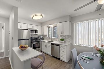Sterling Heights apartment for rent - A modern kitchen with a dining table and chairs.