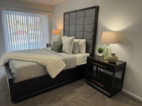 Royal Oak apartment for rent - A bedroom with a large bed and a nightstand with a lamp. at The Park on 13 Apartments - Royal Oak, MI Apartments, Michigan, 48073